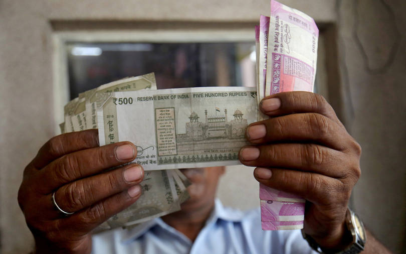 Rupee slips to record low as equity sentiment sours after tax hike